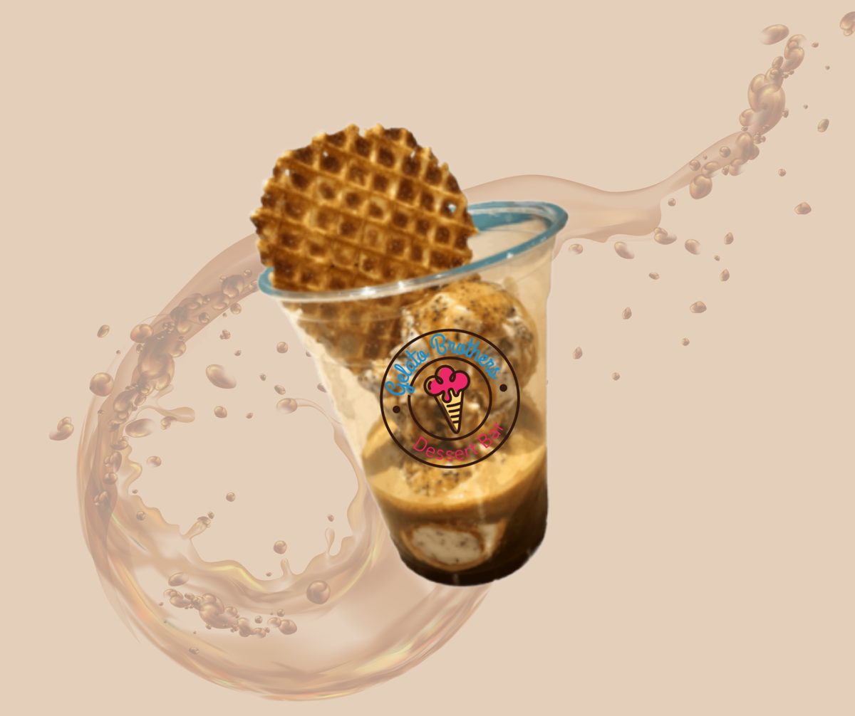 A golden waffle cone sits atop a creamy beverage with a splashing liquid effect against a beige background.