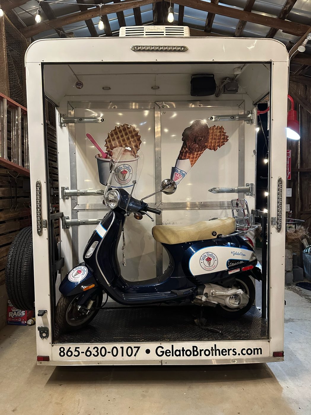 The Gelato Brothers trailer parked in its corral garage at Cedar Pond Farms, the branded Vespa loaded in back